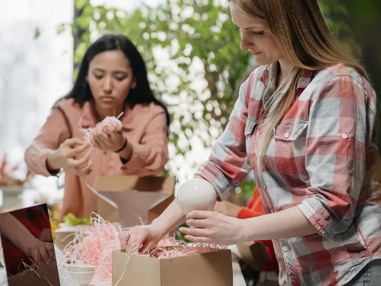 Small-business owners packing orders into boxes.