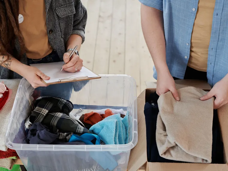 Volunteers recording and packing donated clothing.