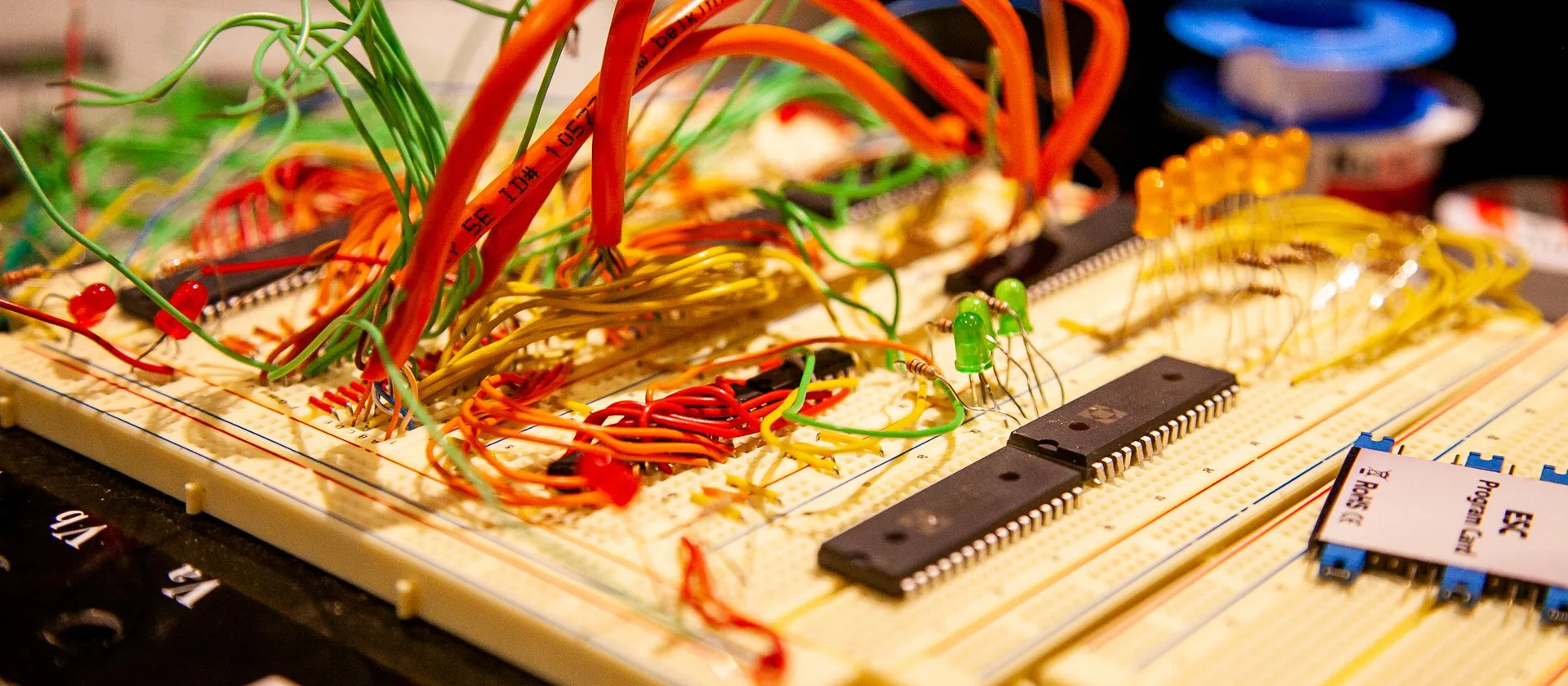 A breadboard with separate components and connected wires, an editorial metaphor for reuse and integration.