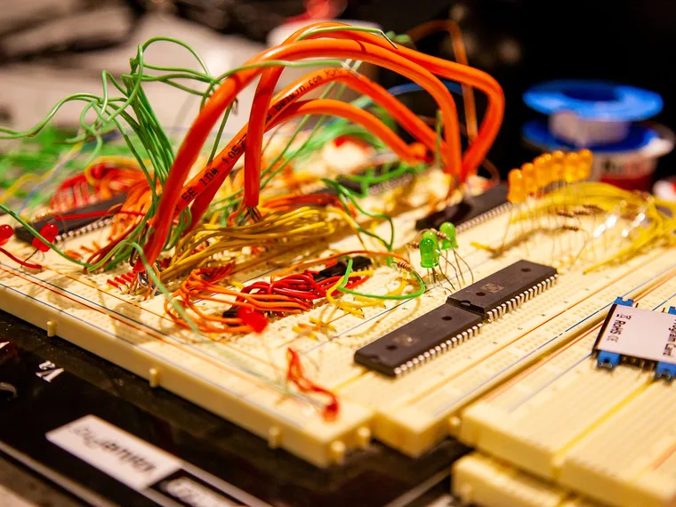 A breadboard with separate components and connected wires, an editorial metaphor for reuse and integration.